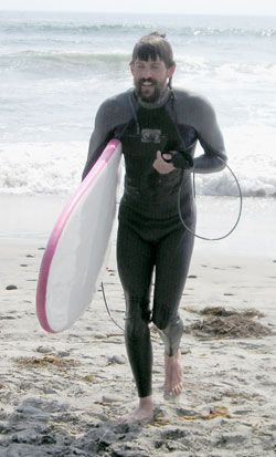 Kai running with surfboard